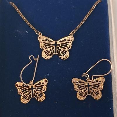 Gold toned Butterfly necklace with cross in the center and matching earrings