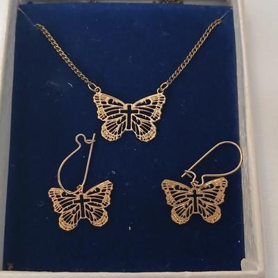 Gold toned Butterfly necklace with cross in the center and matching earrings