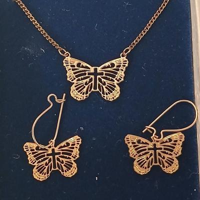 Gold toned Butterfly necklace with cross in the center and matching earrings