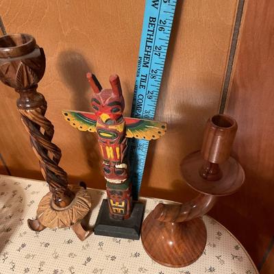 2 wood candle sticks with totem pole decor