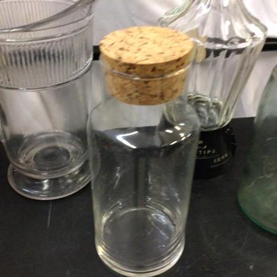 Sale Photo Thumbnail #30: You get a liquor bottle, nice clear glass heavy pitcher,container with large cork, and blue glass canning jar with zink lid.