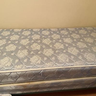 Twin bed with blue comforter