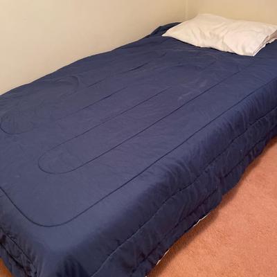 Twin bed with blue comforter