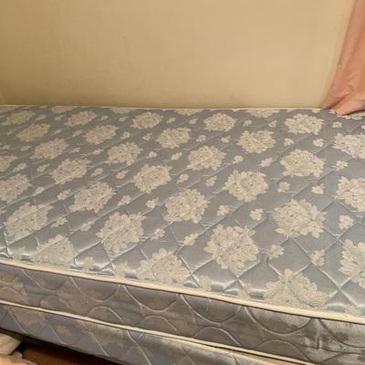 Twin bed with peach comforter