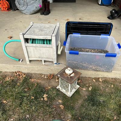 BIRD FEEDER WITH TOTE OF BIRD SEED AND HOSE HIDEAWAY