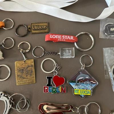 A COLLECTION OF KEYCHAINS, LANYARDS AND MORE