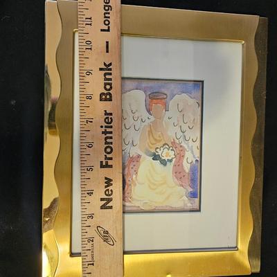 Smaller Angel figures and a framed picture of Angel