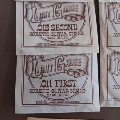 VARIETY OF GUITAR STRINGS AND A PICK