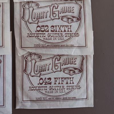 VARIETY OF GUITAR STRINGS AND A PICK