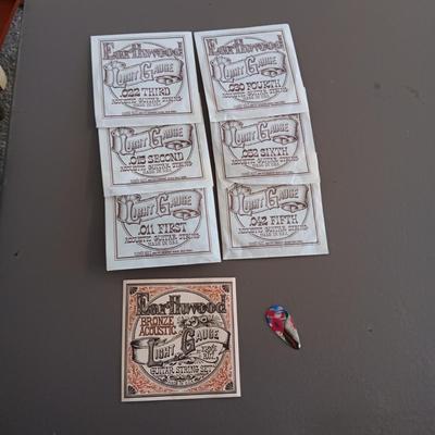 VARIETY OF GUITAR STRINGS AND A PICK