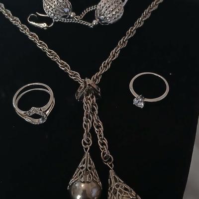 Two women's rings, a necklace and earrings - all silver-toned
