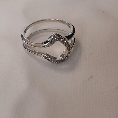 Two women's rings, a necklace and earrings - all silver-toned