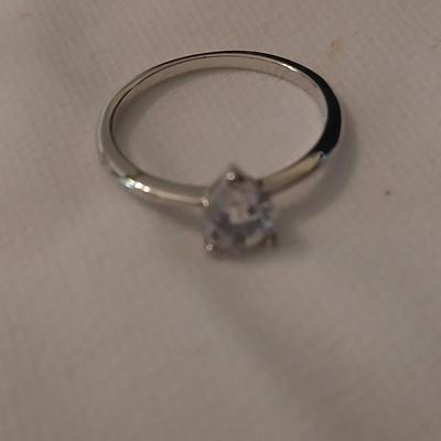 Two women's rings, a necklace and earrings - all silver-toned