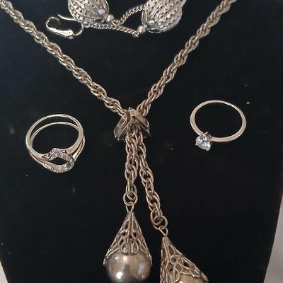 Two women's rings, a necklace and earrings - all silver-toned