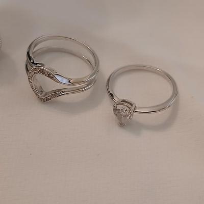 Two women's rings, a necklace and earrings - all silver-toned