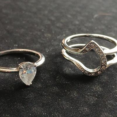 Two women's rings, a necklace and earrings - all silver-toned