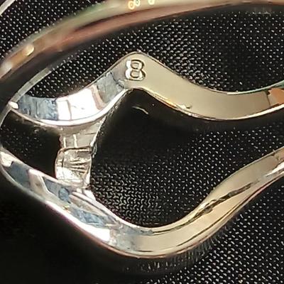 Two women's rings, a necklace and earrings - all silver-toned