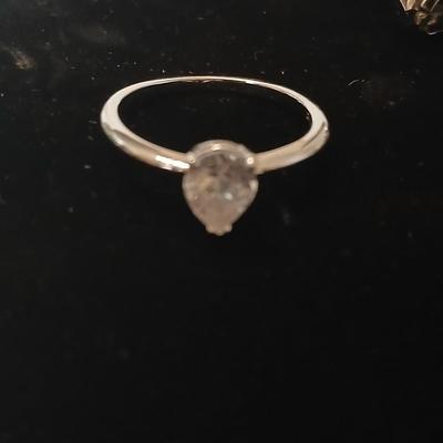 Two women's rings, a necklace and earrings - all silver-toned