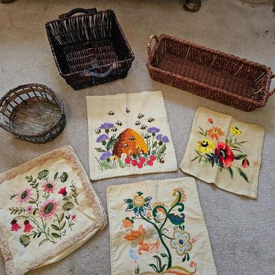 Four Vintage Crewel Embroidery Pillowcases with a variety of wicker baskets and a framed floral embroidered wall art