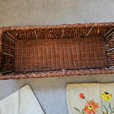 Four Vintage Crewel Embroidery Pillowcases with a variety of wicker baskets and a framed floral embroidered wall art