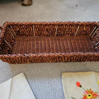 Four Vintage Crewel Embroidery Pillowcases with a variety of wicker baskets and a framed floral embroidered wall art