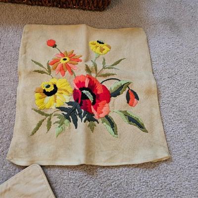 Four Vintage Crewel Embroidery Pillowcases with a variety of wicker baskets and a framed floral embroidered wall art