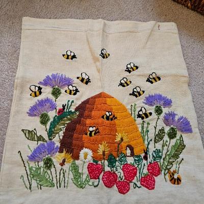 Four Vintage Crewel Embroidery Pillowcases with a variety of wicker baskets and a framed floral embroidered wall art