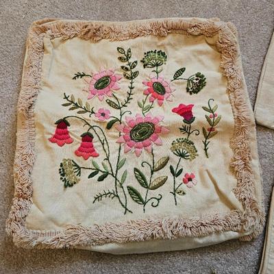 Four Vintage Crewel Embroidery Pillowcases with a variety of wicker baskets and a framed floral embroidered wall art