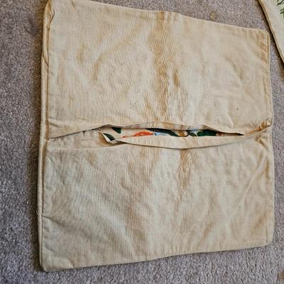 Four Vintage Crewel Embroidery Pillowcases with a variety of wicker baskets and a framed floral embroidered wall art