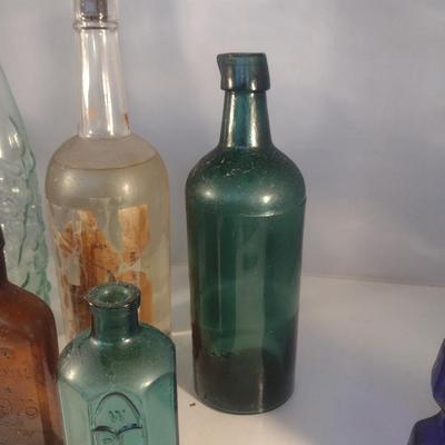Collection of Vintage Glass Bottles- Clear, Blue, Green, and Amber
