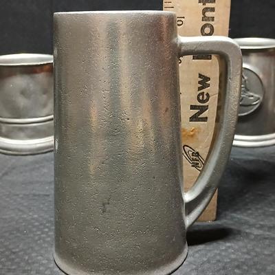 Four Pewter Collectible Beer Steins - One with a bell in the bottom.