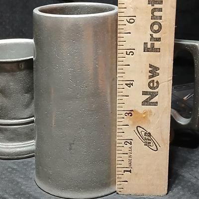 Four Pewter Collectible Beer Steins - One with a bell in the bottom.