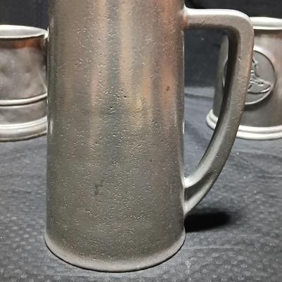 Four Pewter Collectible Beer Steins - One with a bell in the bottom.
