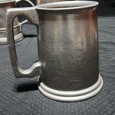 Four Pewter Collectible Beer Steins - One with a bell in the bottom.