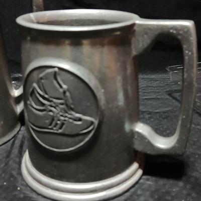 Four Pewter Collectible Beer Steins - One with a bell in the bottom.
