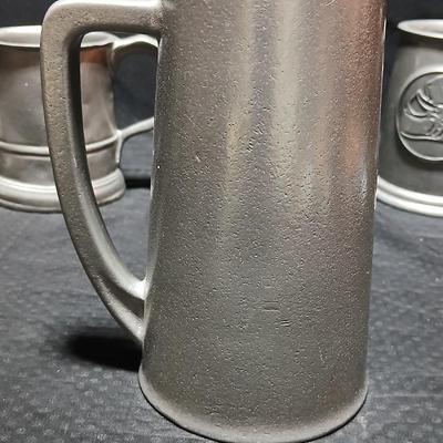 Four Pewter Collectible Beer Steins - One with a bell in the bottom.