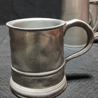 Four Pewter Collectible Beer Steins - One with a bell in the bottom.
