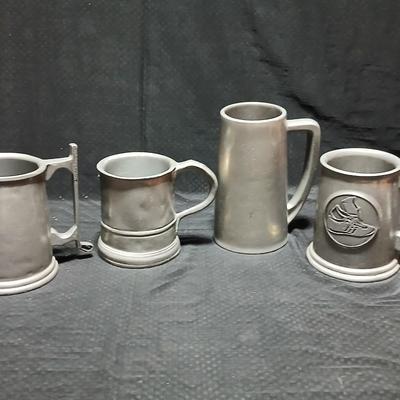 Four Pewter Collectible Beer Steins - One with a bell in the bottom.