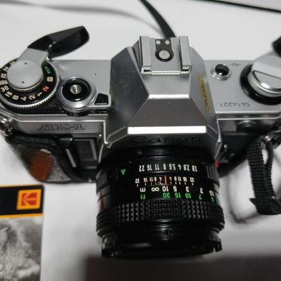 Classic Canon AE-1 with 50mm F1.8 Lens with many accessories and original manuals and more !