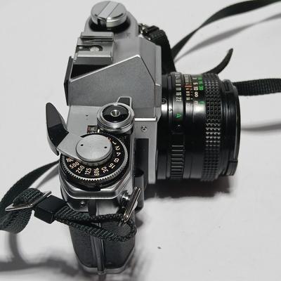 Classic Canon AE-1 with 50mm F1.8 Lens with many accessories and original manuals and more !