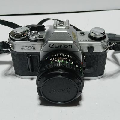 Classic Canon AE-1 with 50mm F1.8 Lens with many accessories and original manuals and more !