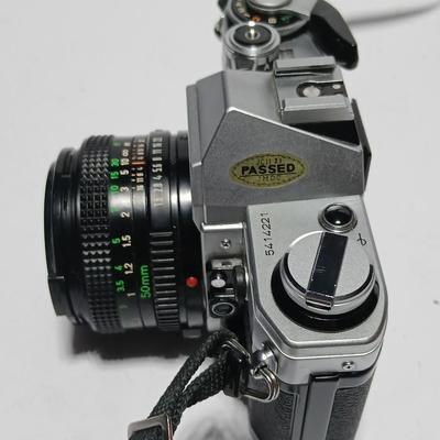 Classic Canon AE-1 with 50mm F1.8 Lens with many accessories and original manuals and more !