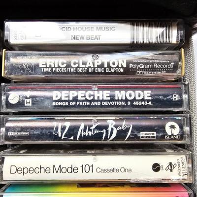 Cassette tapes rock and roll and others in an organizer bag with a vintage GE AM-FM sportsman radio cassette player