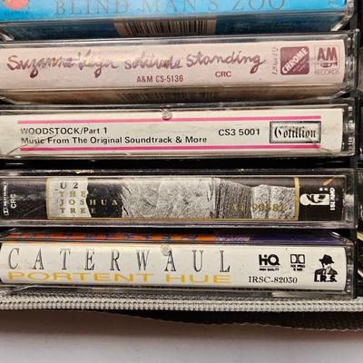 Cassette tapes rock and roll and others in an organizer bag with a vintage GE AM-FM sportsman radio cassette player