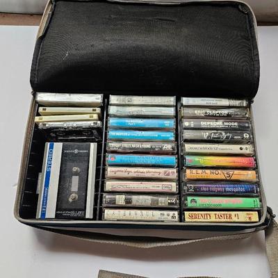 Cassette tapes rock and roll and others in an organizer bag with a vintage GE AM-FM sportsman radio cassette player