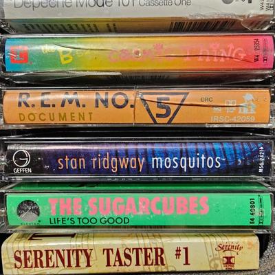 Cassette tapes rock and roll and others in an organizer bag with a vintage GE AM-FM sportsman radio cassette player
