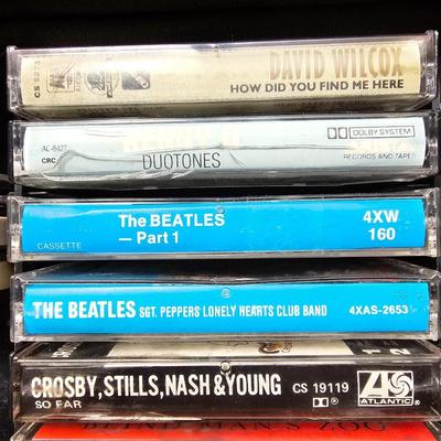 Cassette tapes rock and roll and others in an organizer bag with a vintage GE AM-FM sportsman radio cassette player