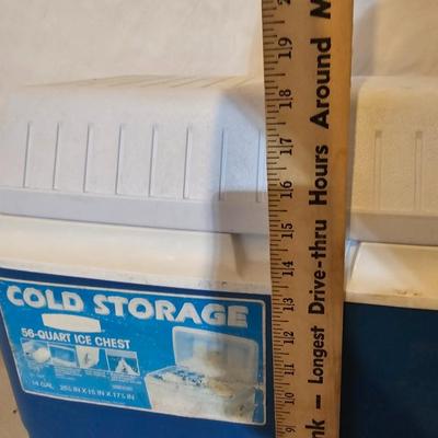 Rubbermaid 50 Quart cooler with two fishpoles, tackle box, and a water bottle