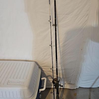 Rubbermaid 50 Quart cooler with two fishpoles, tackle box, and a water bottle
