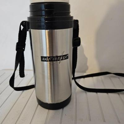 Rubbermaid 50 Quart cooler with two fishpoles, tackle box, and a water bottle